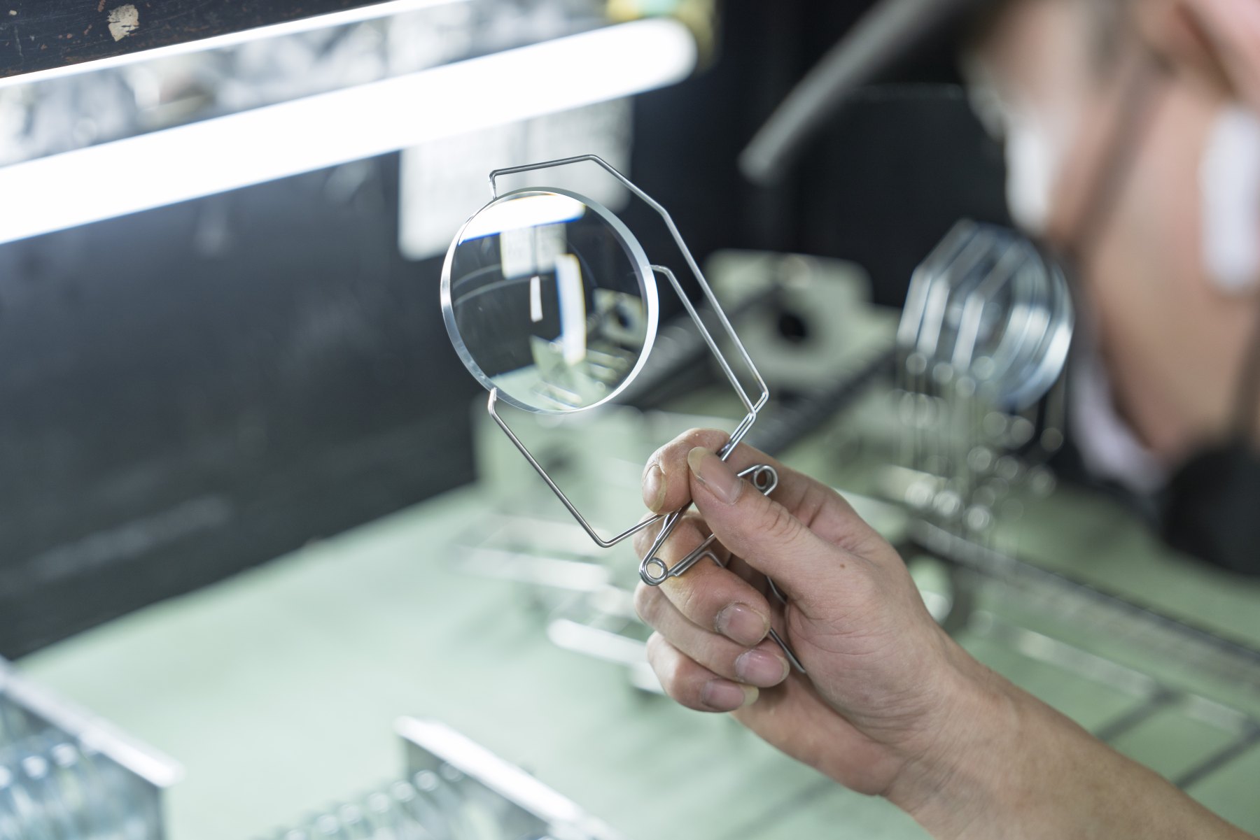 A lens being inspected under a light