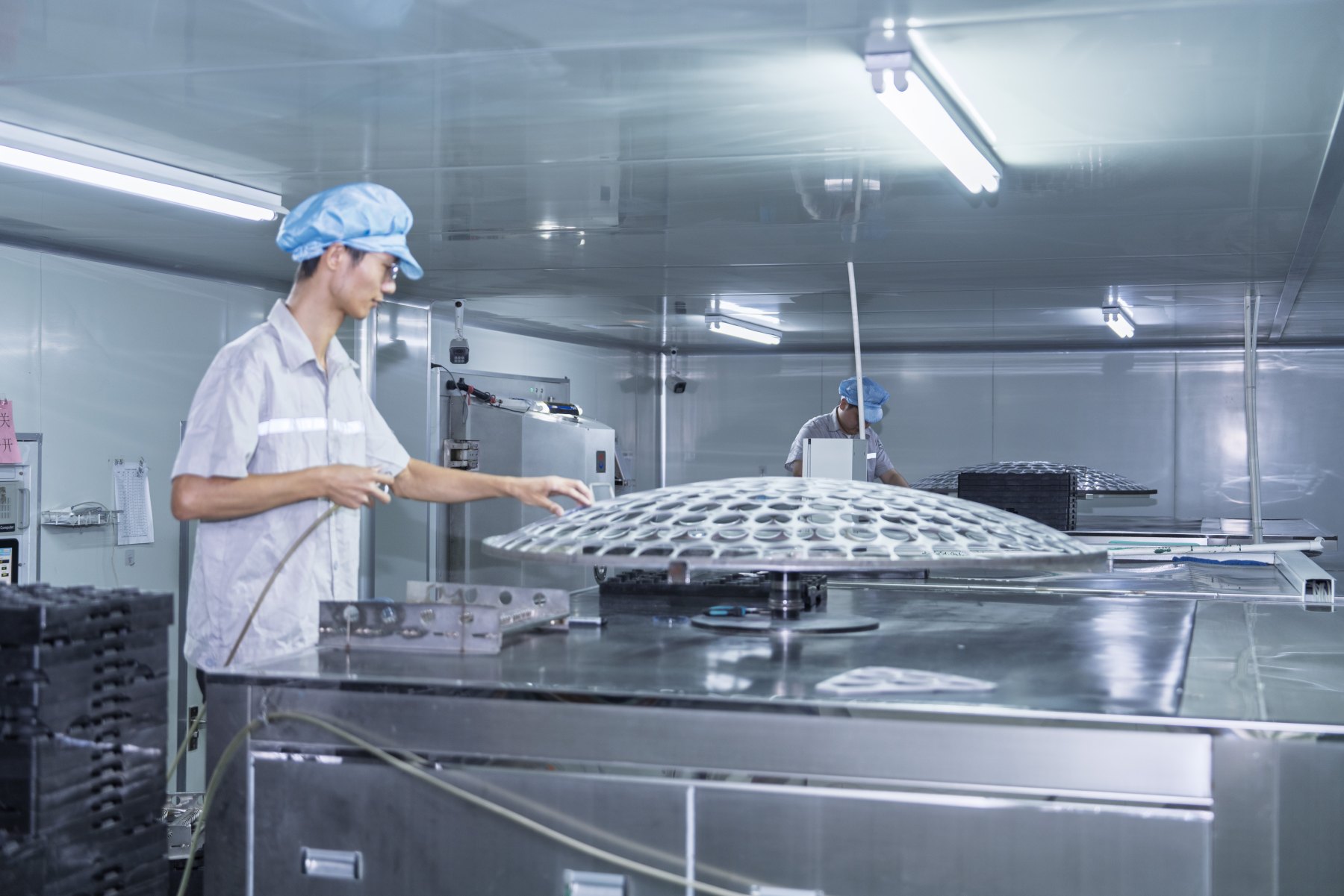 Staff working on a lens production floor